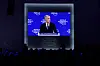 Mark Carney vises på blå WEF-storskjerm foran publikum i Davos