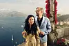 Anders og Anette de la Motte står med vinglass på en terrasse med utsikt over hav og kyst i Italia.