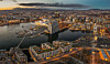 Aftenfoto av Oslo med opplyst havn, Munchmuseet, Operaen og byens skyline.