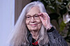 Marilynne Robinson smiler og løfter hånden til brillene under et arrangement på Slottet.