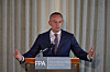 Nickolay Mladenov stands behind an FPA lectern, speaking with arms raised during a press briefing.