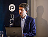 Per Axel Koch står ved en laptop foran en Polaris Media-bakgrunn under presentasjon av kvartalstall.