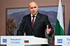 Rumen Radev taler ved en talerstol med bulgarsk flagg i bakgrunnen.