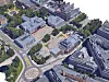 Luftfoto av et tett byområde med historiske bygninger, parker og en rundkjøring.